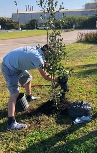 Student Plants a Tree at Big Event