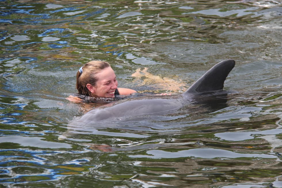 Rhiannon Nechero swimming with a dolphin.